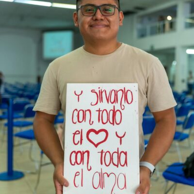 A man holding a sign that says, you can't change the world