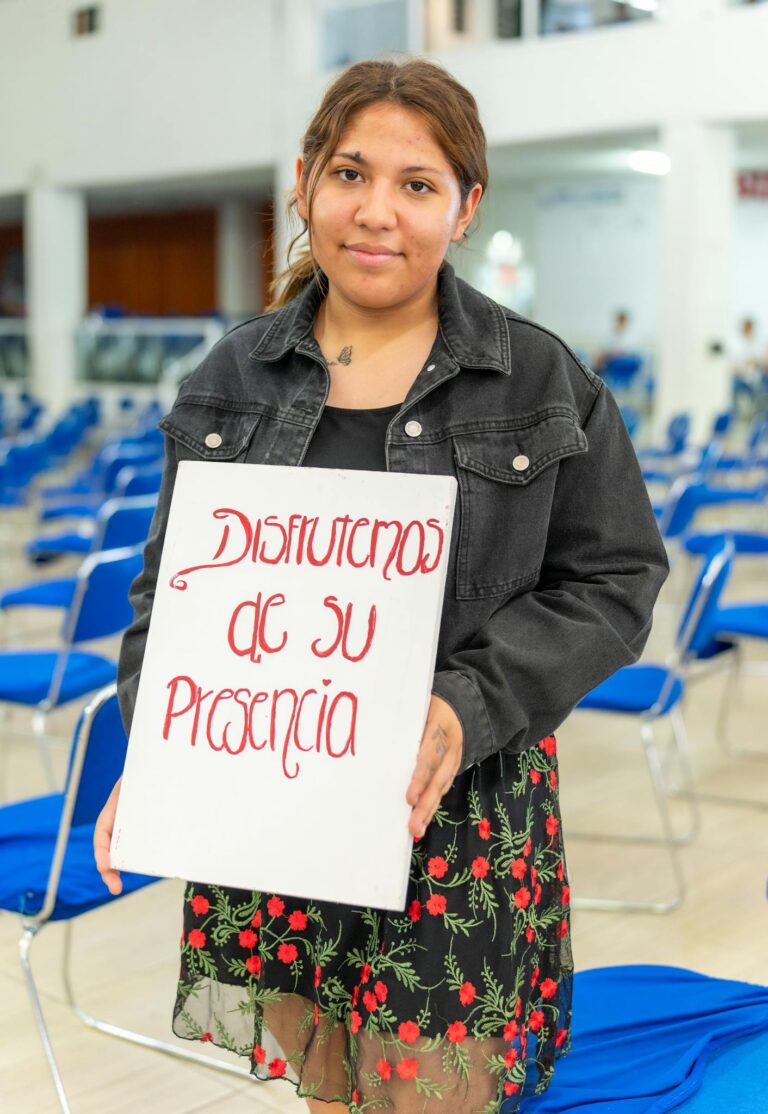 A woman holding a sign that says, don't give up on me